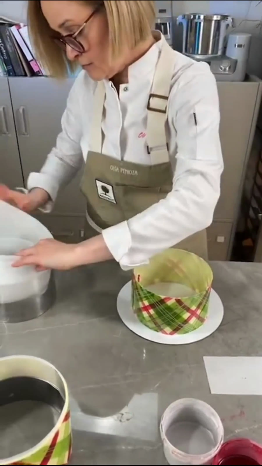 A finished chocolate collar with a pattern is placed onto a cake