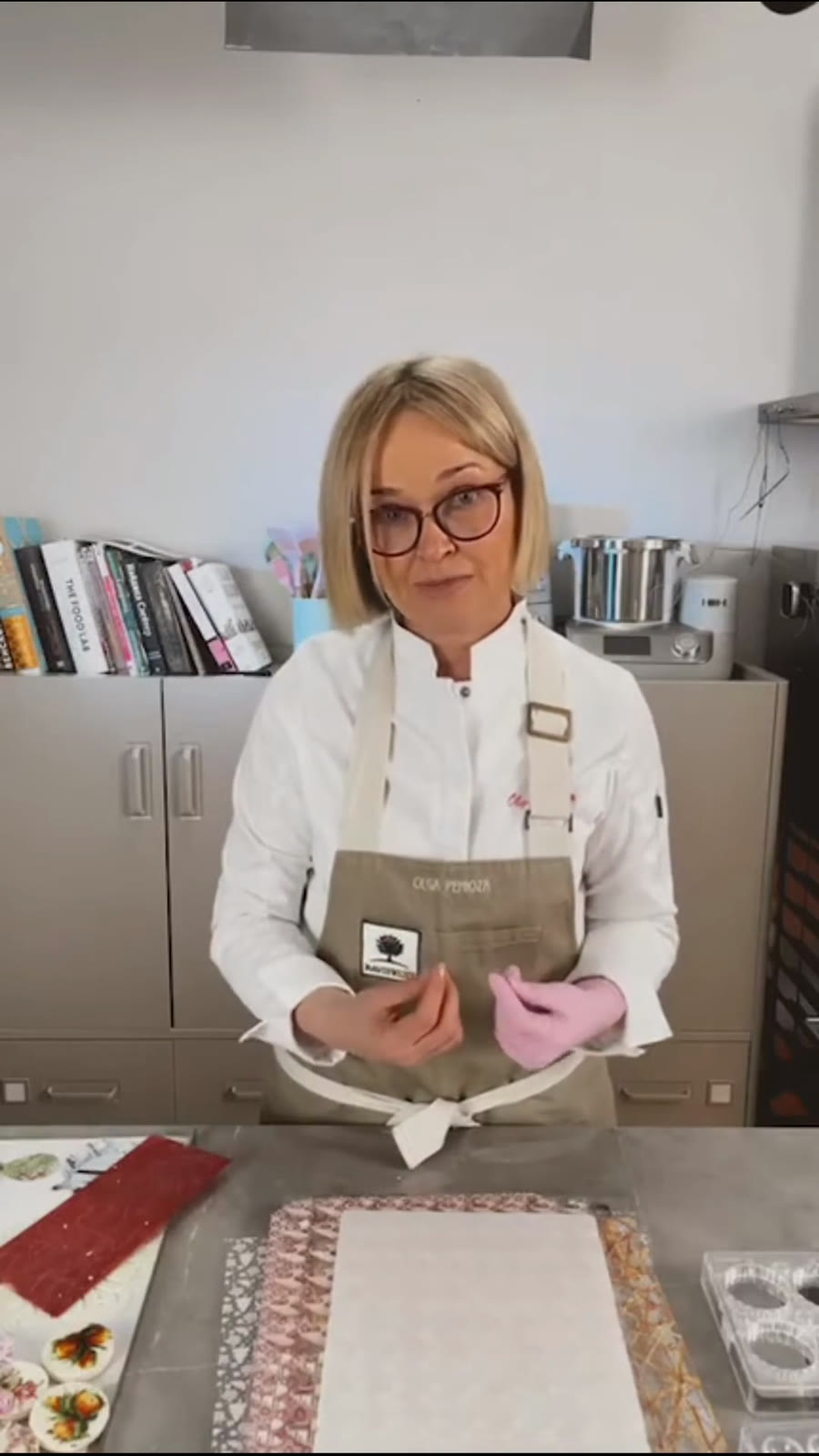 Olga Penioza shows finished chocolate transfers in different colors and shapes